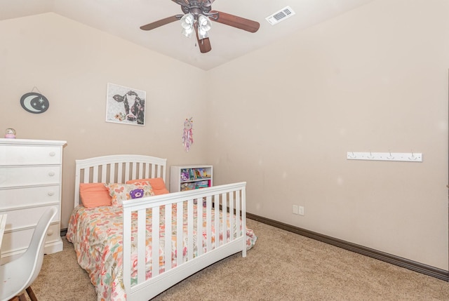 bedroom with carpet flooring, a ceiling fan, visible vents, baseboards, and vaulted ceiling