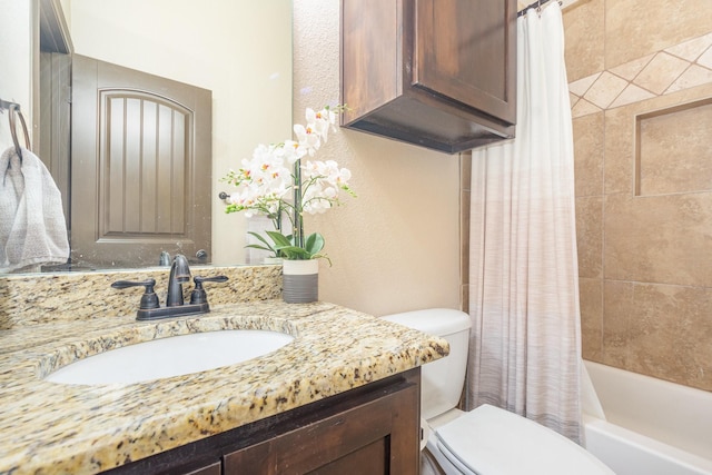 full bathroom with vanity, toilet, a textured wall, and shower / tub combo