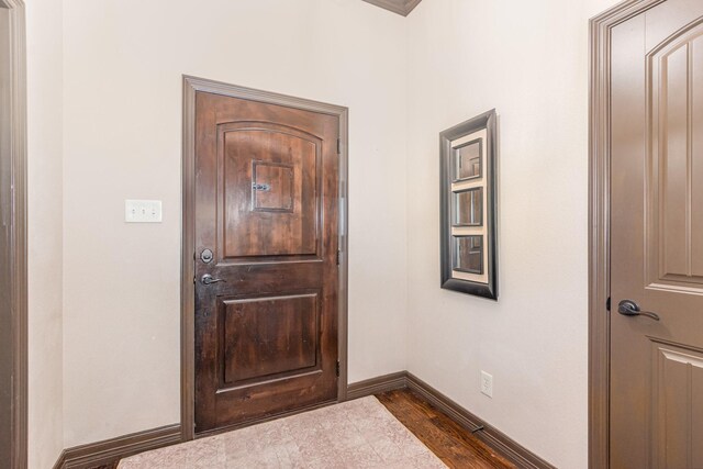 interior space featuring dark wood-style flooring and baseboards