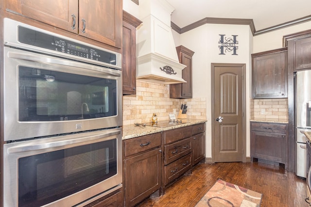 kitchen with stainless steel appliances, custom exhaust hood, decorative backsplash, light stone counters, and ornamental molding