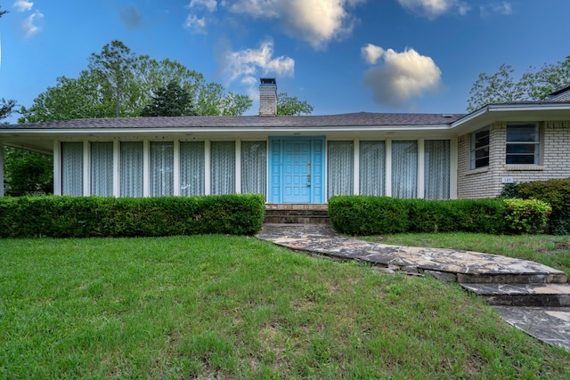109 Pecan Dr, Rowlett, TX 75087 - view of front of home featuring a chimney and a front yard