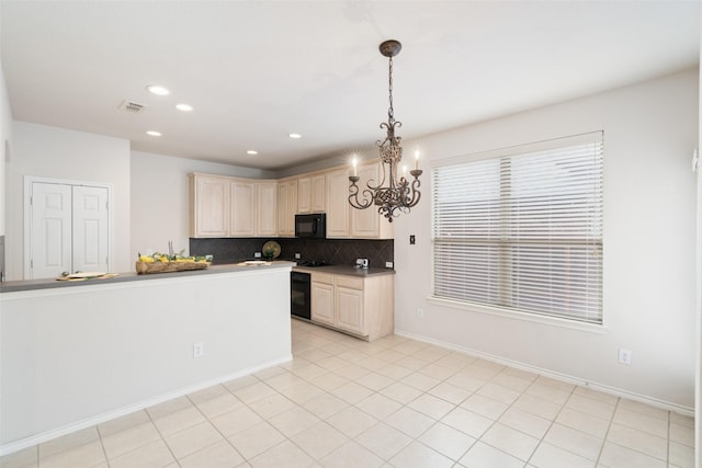 kitchen featuring backsplash, visible vents, black microwave, hanging light fixtures, and a chandelier