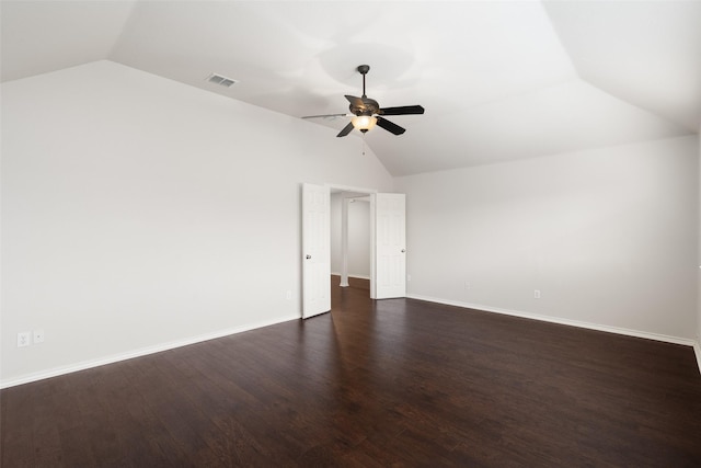 unfurnished room with a ceiling fan, baseboards, lofted ceiling, visible vents, and dark wood-style floors