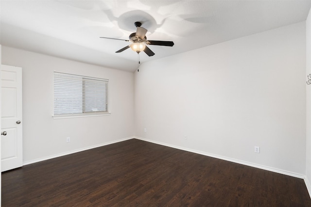empty room with baseboards, a ceiling fan, and dark wood-style floors
