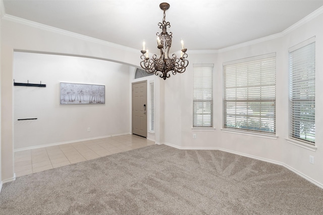empty room with carpet flooring, tile patterned floors, a chandelier, and ornamental molding