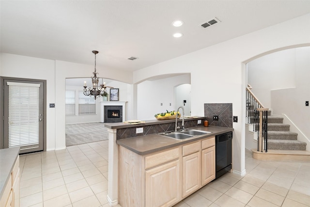 kitchen with visible vents, dishwasher, a sink, light brown cabinets, and light tile patterned flooring