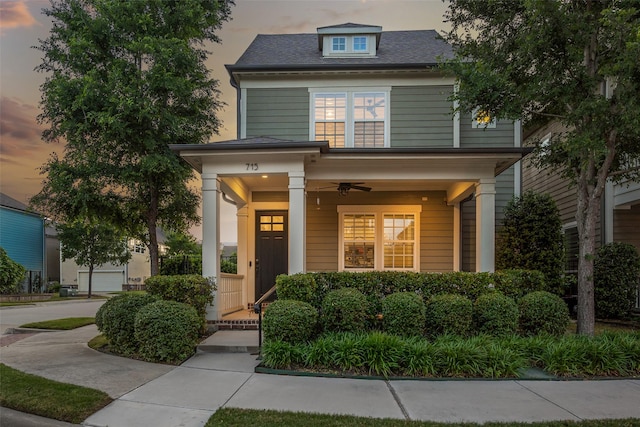 american foursquare style home featuring a porch and ceiling fan
