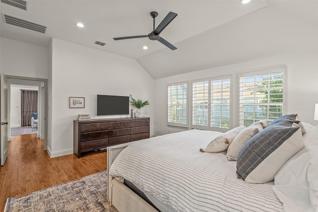 bedroom featuring visible vents, lofted ceiling, and multiple windows