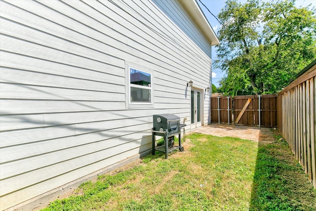 view of yard with a fenced backyard and a gate