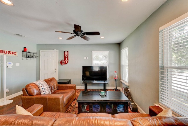 living room featuring a ceiling fan, visible vents, wood finished floors, baseboards, and recessed lighting