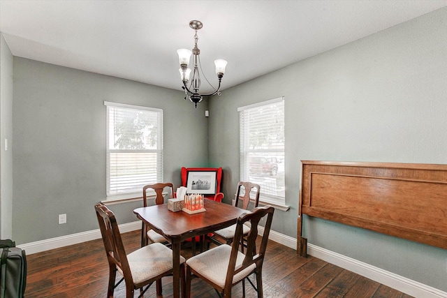dining space featuring baseboards, dark wood-style flooring, and a notable chandelier