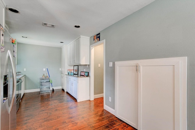 kitchen featuring baseboards, dark wood-type flooring, white cabinetry, and visible vents