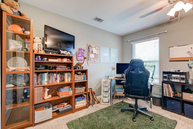 carpeted office space featuring ceiling fan and visible vents