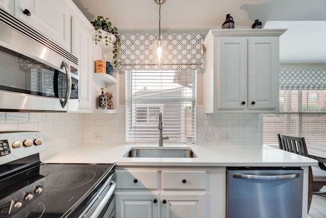 kitchen featuring light countertops, a sink, tasteful backsplash, and stainless steel appliances