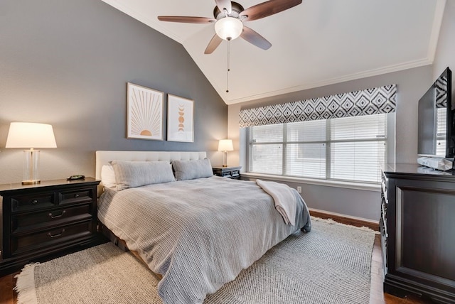 bedroom with a ceiling fan, wood finished floors, baseboards, lofted ceiling, and ornamental molding