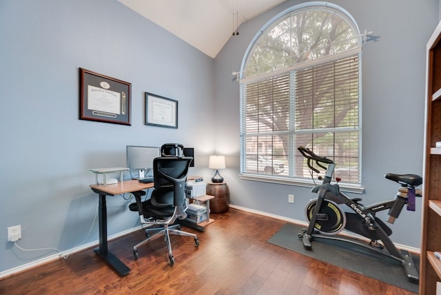 home office featuring baseboards, vaulted ceiling, and wood finished floors