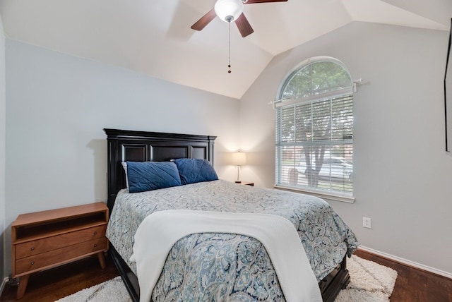 bedroom with baseboards, a ceiling fan, wood finished floors, and lofted ceiling