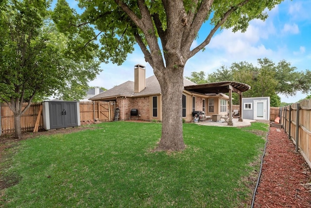 rear view of property featuring a patio, a fenced backyard, a chimney, a storage shed, and an outbuilding