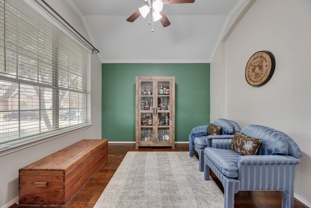 sitting room featuring ceiling fan, vaulted ceiling, ornamental molding, and wood finished floors