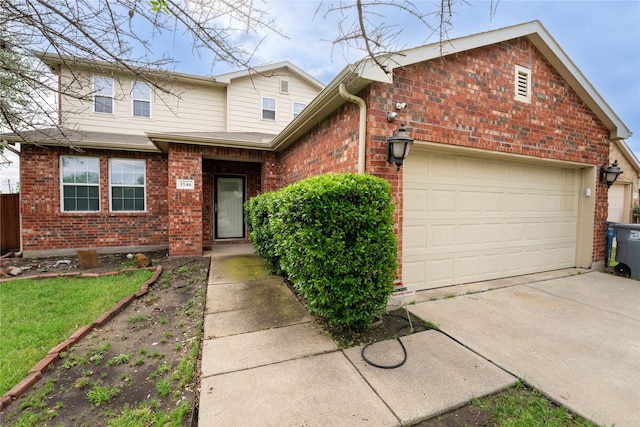 traditional-style house featuring an attached garage, concrete driveway, and brick siding