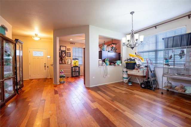 entrance foyer featuring hardwood / wood-style floors and a notable chandelier