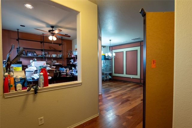 hall with an inviting chandelier, hardwood / wood-style floors, recessed lighting, baseboards, and visible vents