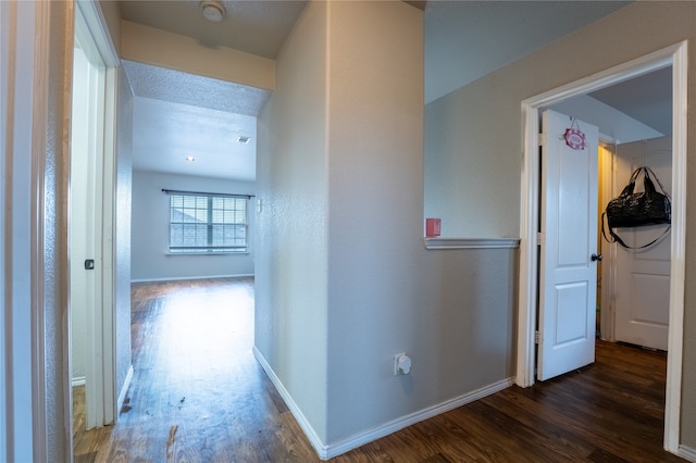 hallway featuring baseboards and wood finished floors