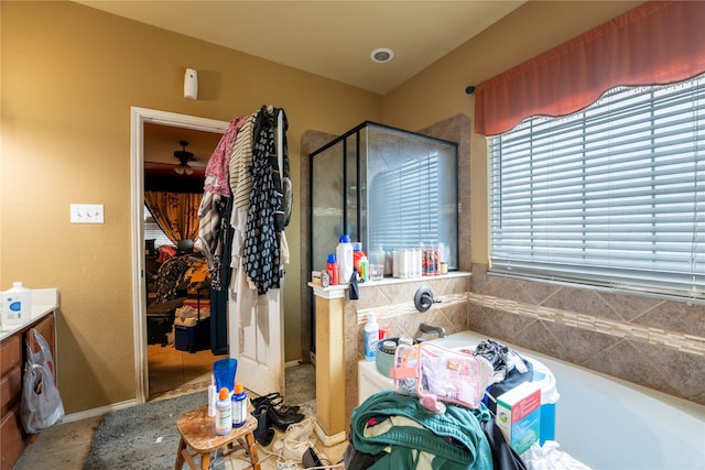 bathroom featuring a garden tub and a shower stall