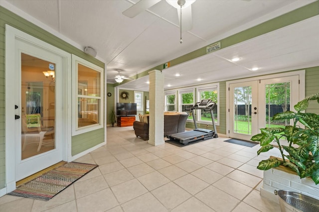 sunroom / solarium featuring french doors