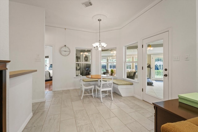dining space with visible vents, baseboards, and a notable chandelier