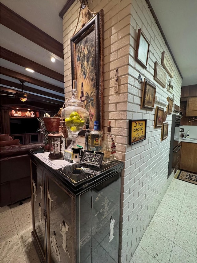 kitchen with brick wall and beam ceiling