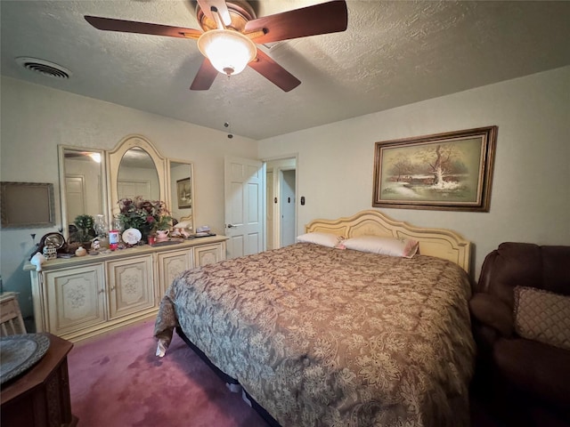 carpeted bedroom with ceiling fan, a textured ceiling, and visible vents