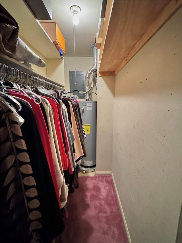 spacious closet featuring carpet floors and electric water heater