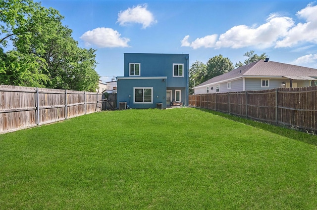 1933 Shaw St, Dallas, TX 75212 - rear view of property featuring a lawn, stucco siding, cooling unit, and a fenced backyard