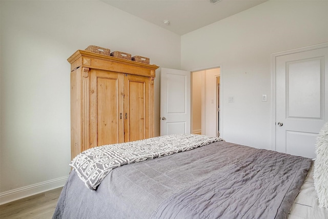 bedroom featuring light wood-style floors and baseboards