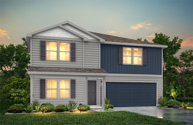 view of front of home with a garage, driveway, and roof with shingles