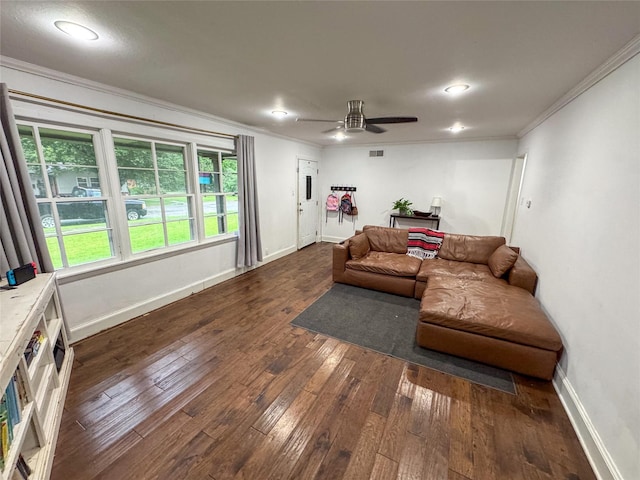 living room with baseboards, ornamental molding, ceiling fan, and dark wood-style floors