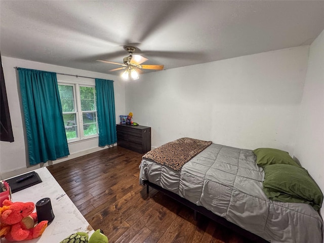 bedroom with a ceiling fan and hardwood / wood-style flooring