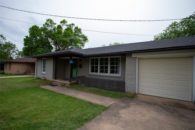 single story home featuring brick siding, aphalt driveway, an attached garage, and a front yard