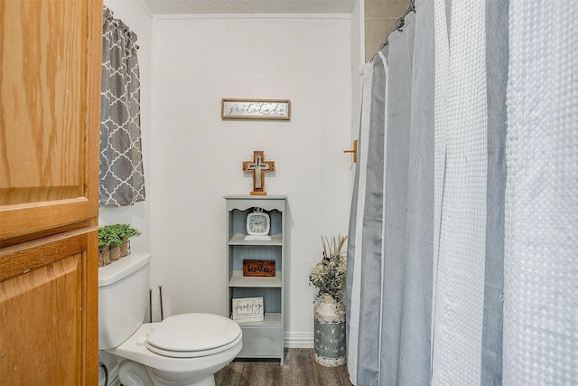 bathroom with toilet and wood finished floors