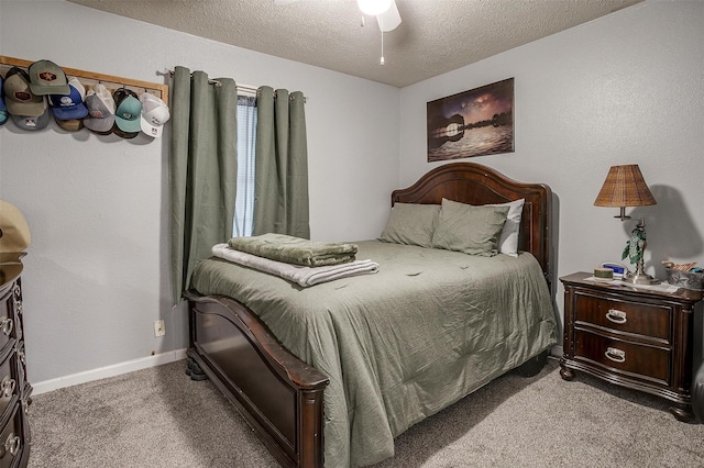 carpeted bedroom with baseboards, ceiling fan, and a textured ceiling