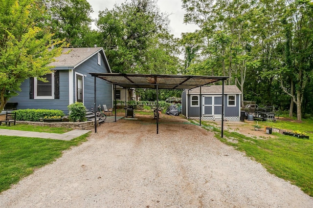 ranch-style house featuring an outdoor structure, a front yard, a storage shed, and driveway