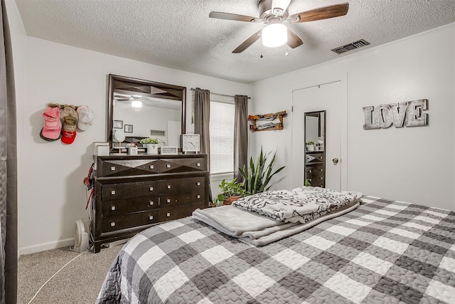 bedroom with carpet flooring, a ceiling fan, a textured ceiling, and visible vents