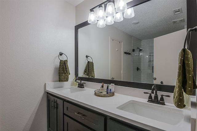 full bathroom featuring visible vents, a sink, and a stall shower