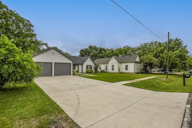 view of front of home featuring an attached garage, concrete driveway, and a front lawn