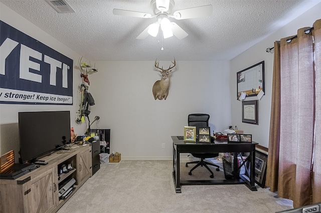 office with ceiling fan, light colored carpet, a textured ceiling, and visible vents