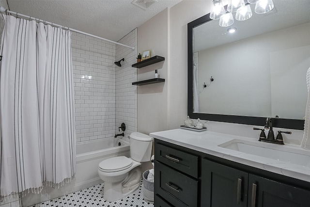 full bathroom featuring a textured ceiling, visible vents, vanity, toilet, and shower / bath combo with shower curtain