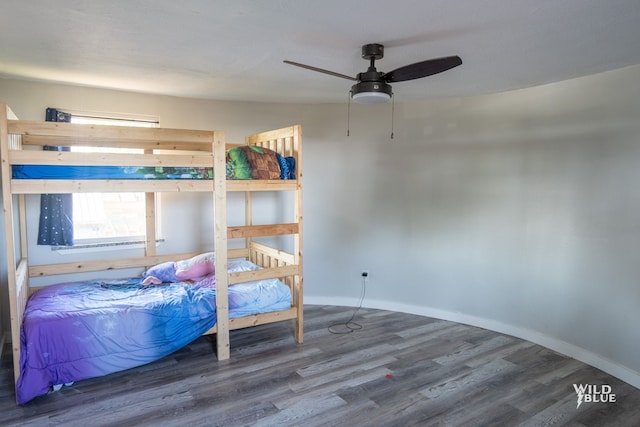 bedroom with baseboards, a ceiling fan, and wood finished floors