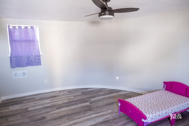 bedroom with ceiling fan, baseboards, visible vents, and wood finished floors