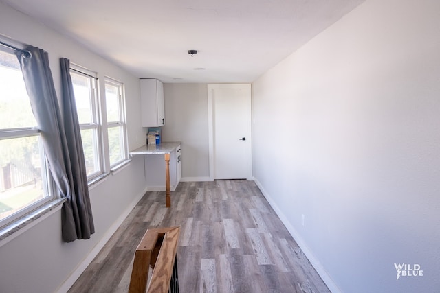 interior space featuring light wood-type flooring and baseboards